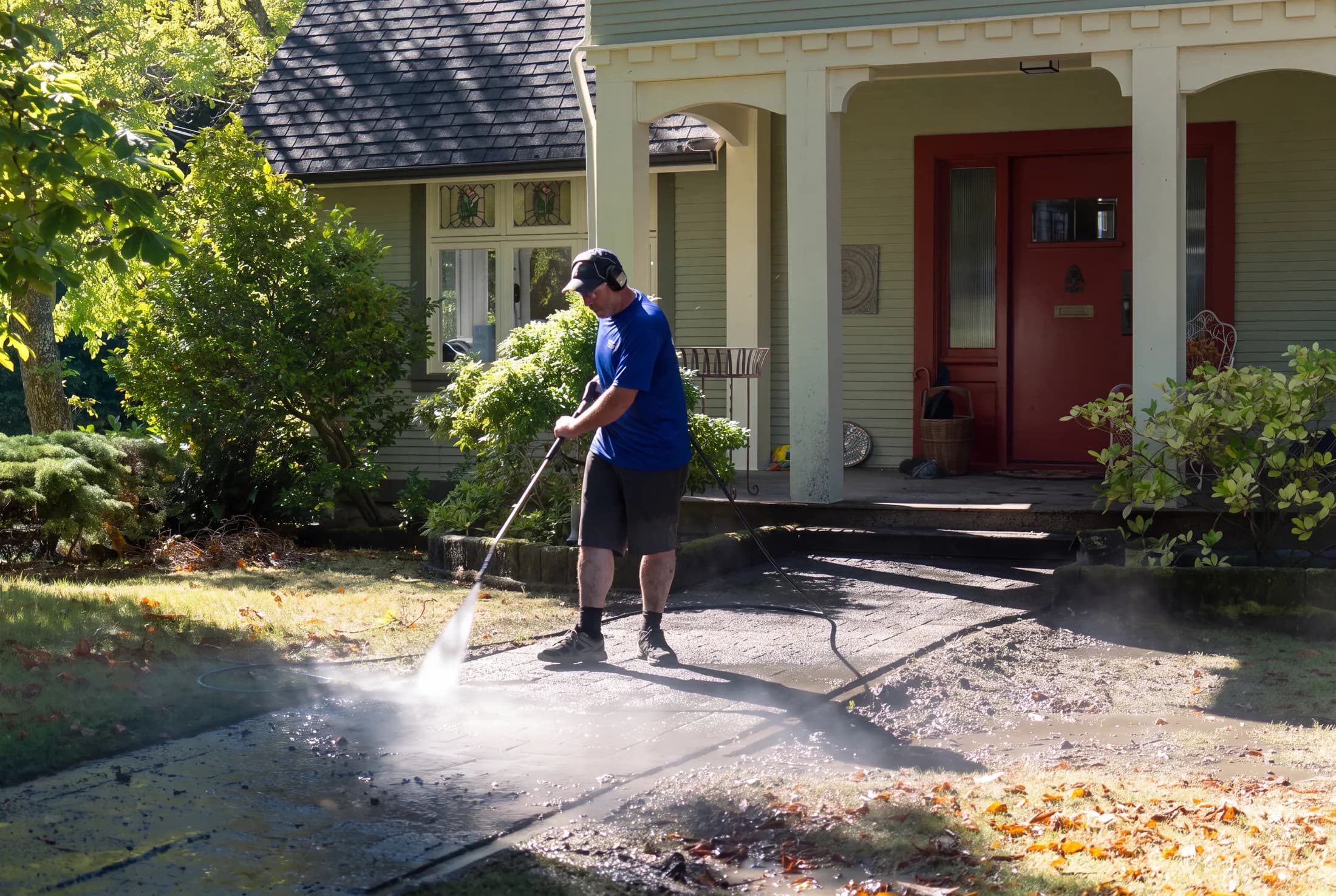 Holland Home Services crew pressure washing a walkway