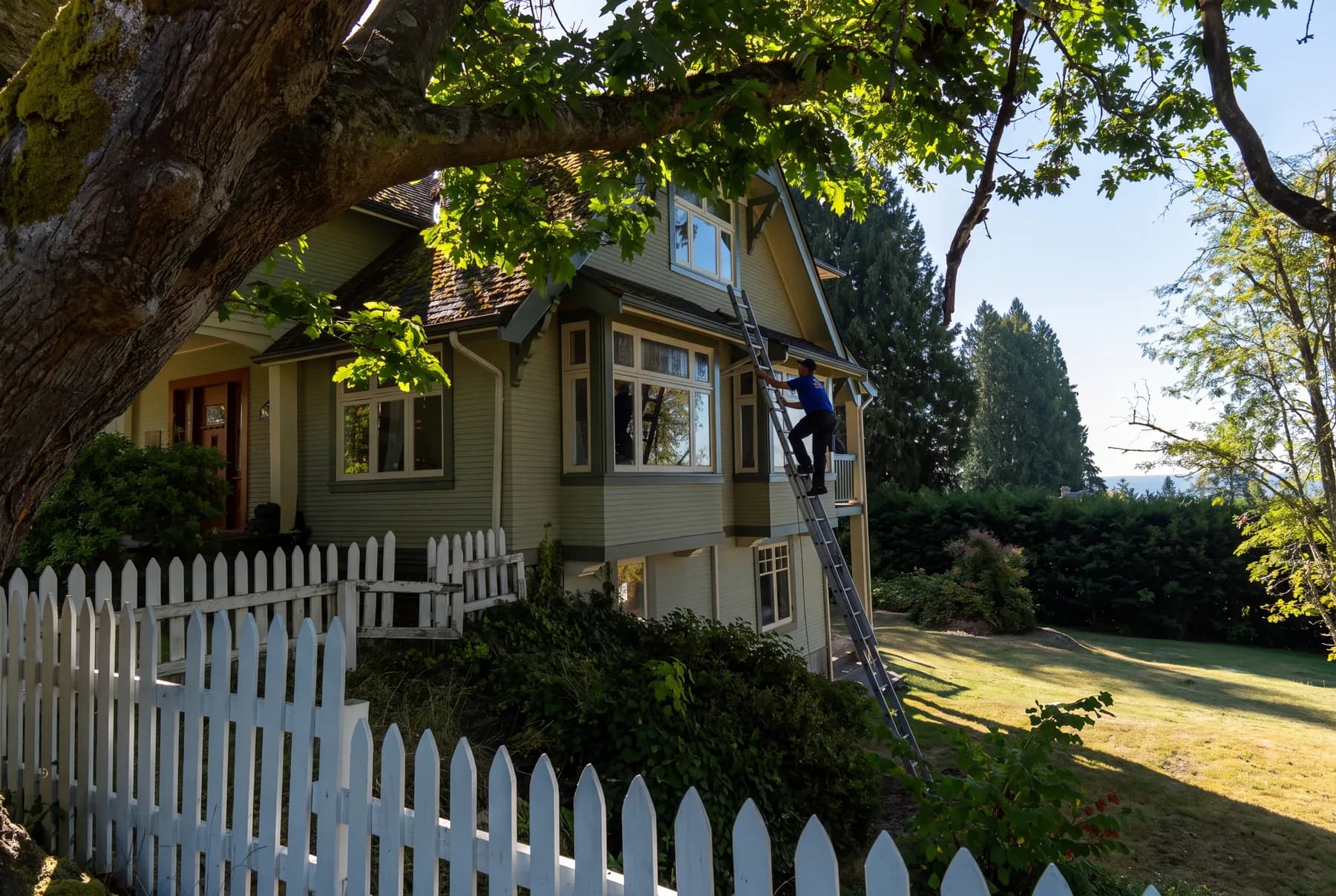 Holland Home Services crew cleaning second-storey windows